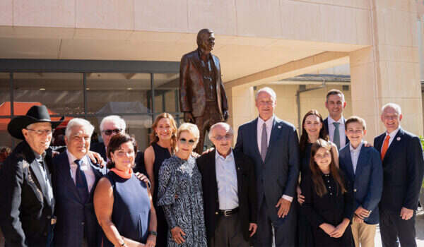 University leaders, Harvey Najim and the Alvarez family pose for a group photo