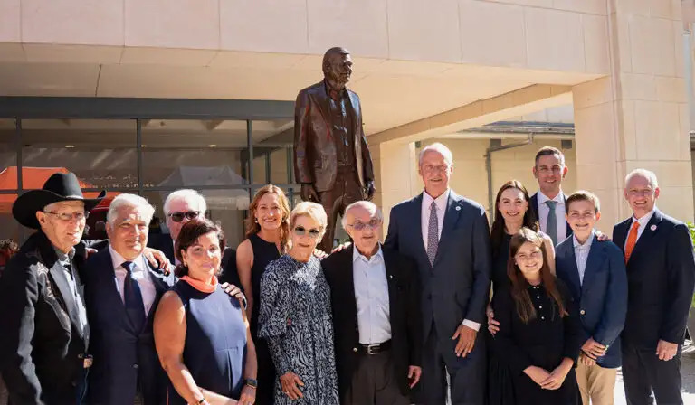 University leaders, Harvey Najim and the Alvarez family pose for a group photo