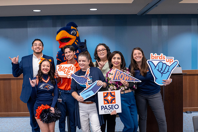 Students and staff giving birds up with Rowdy