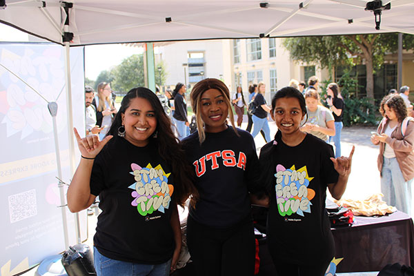 Three students at an Adobe event