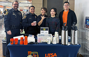 Three UTSA police officers and two students at a coffee station.