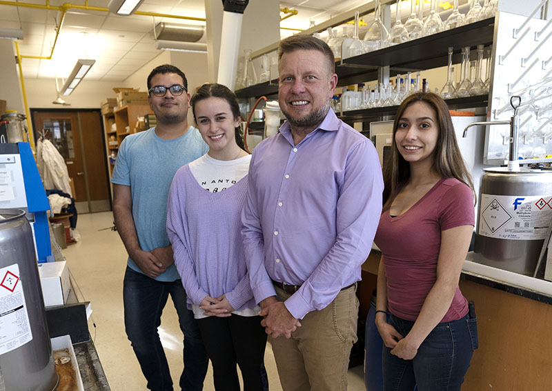 Dr. Doug Frantz and students smiling in lab
