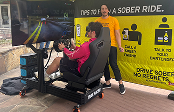 Student at a drunk driving virtual simulator.