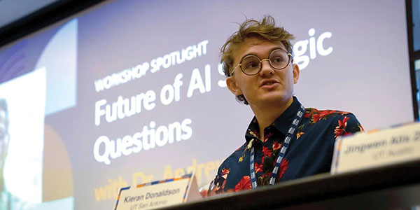 Student on stage participating on an AI forum