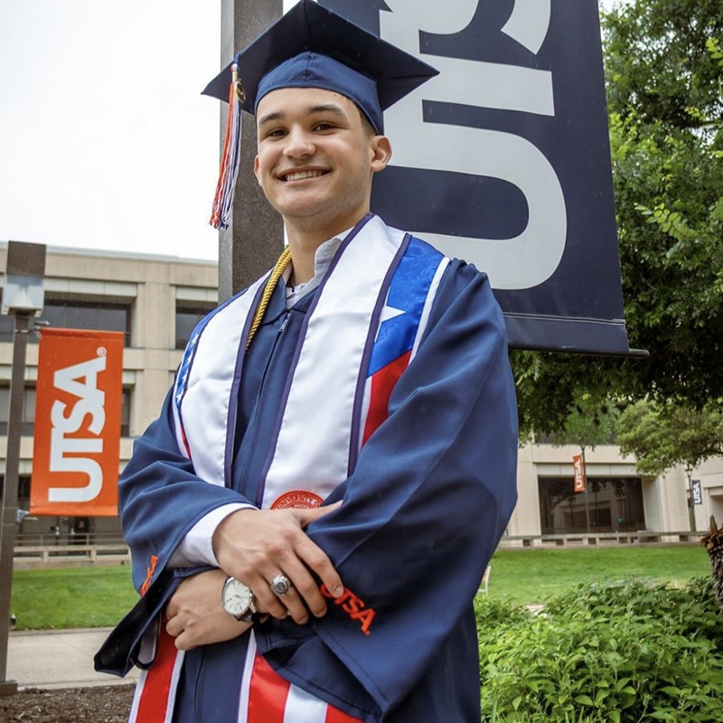 Proud UTSA graduate showing class ring on UTSA campus