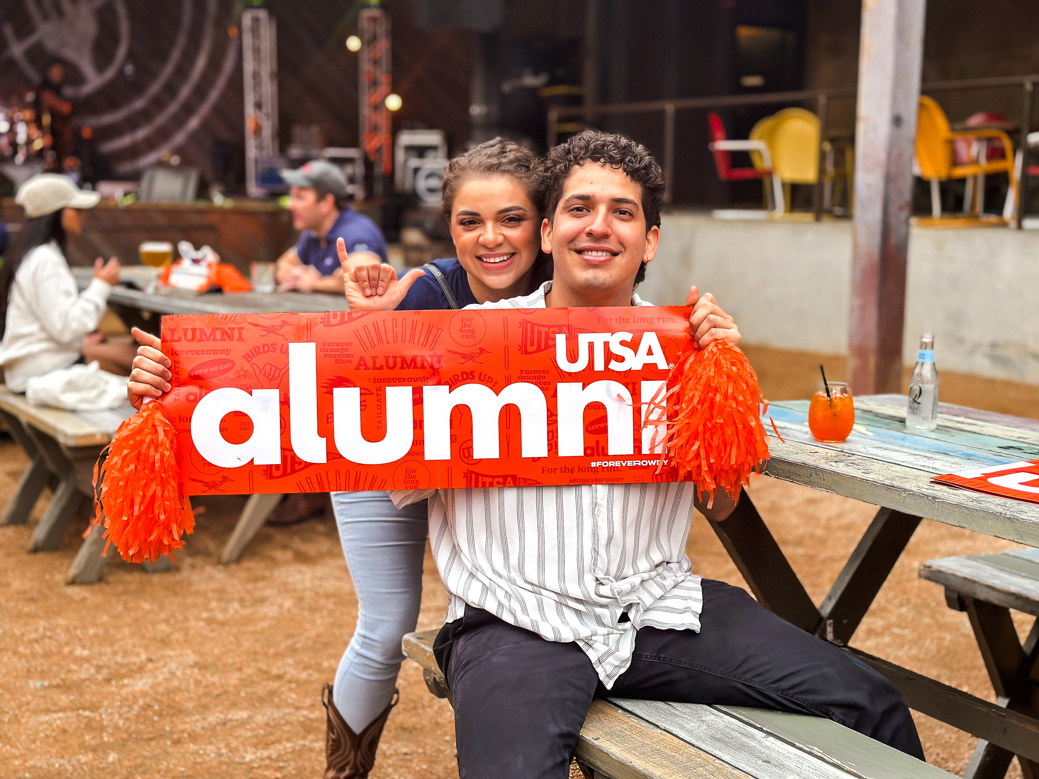 UTSA Alumni Couple holding UTSA sign