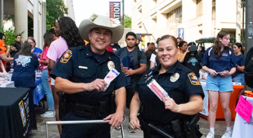 Two UTSA police officers at an event.
