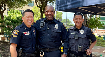 Three UTSA police officers smiling.