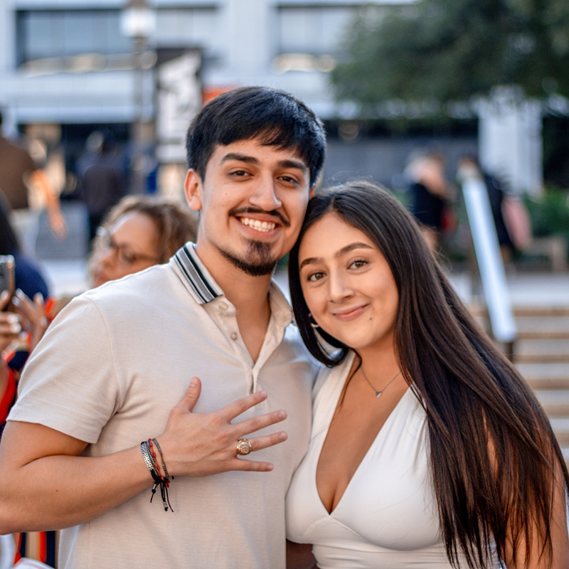 Student showing his UTSA ring with girlfriend