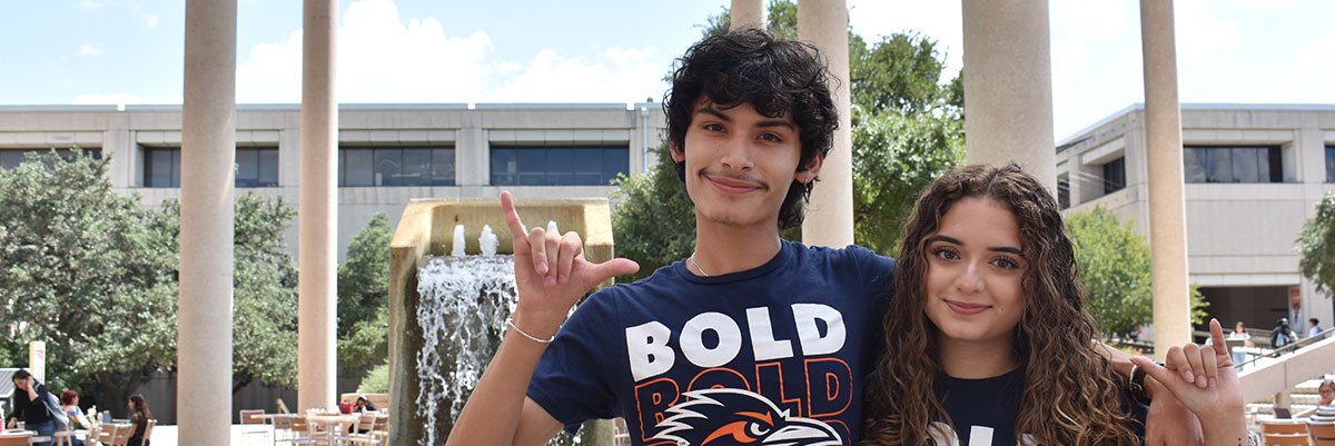 Two students at the Sombrilla with Bold Scholars shirts