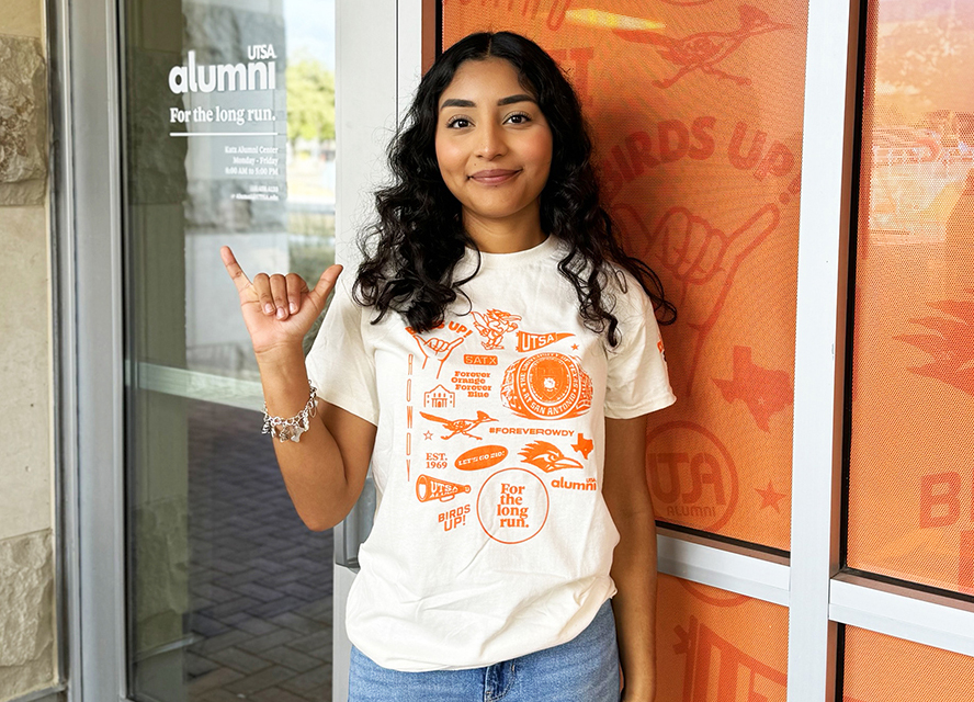 UTSA students doing birds up in front of KATZ Alumni Center