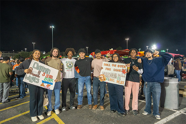 Students holding signs at a student event