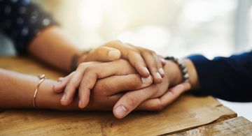 Two people holding hands.