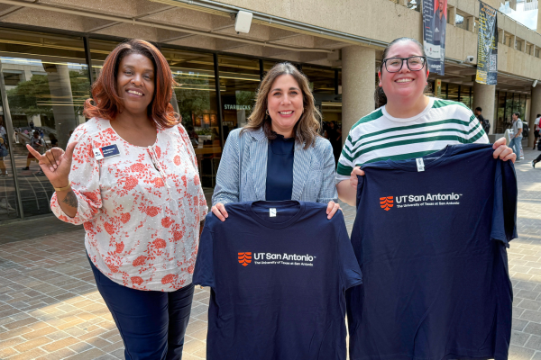 Photo of three UTSA Student Affairs staff members two are holding utsa shirts and one is doing the utsa birds up gesture