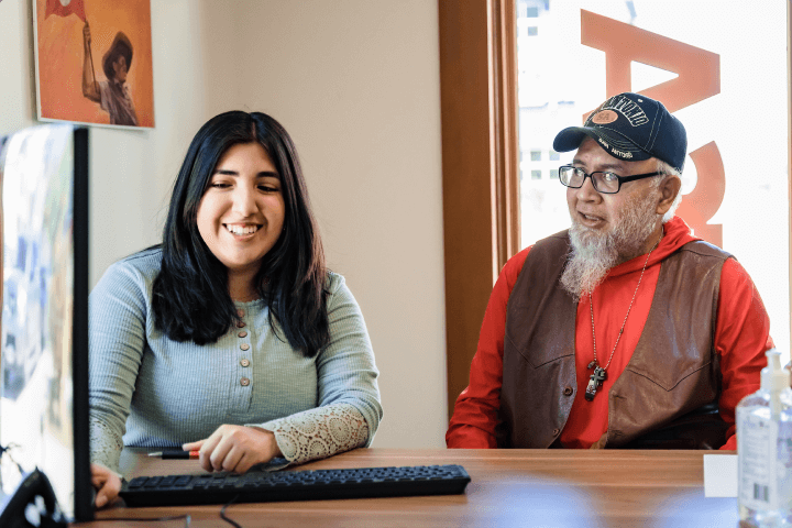 Female student with older male sitting in front of a desk