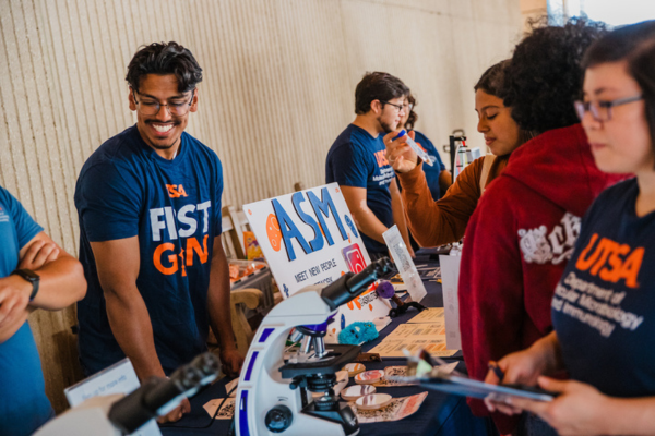 Students at a table during an info fair