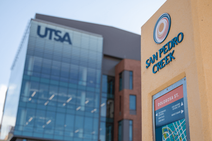 Downtown Campus at UT San Antonio with a San Pedro Creek sign