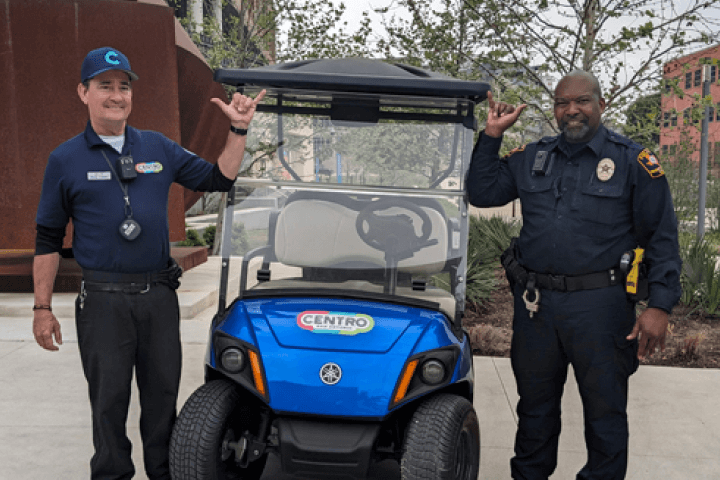Campus Safety Escorts standing next to a golf cart